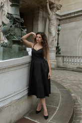 a lady in a black slip dress